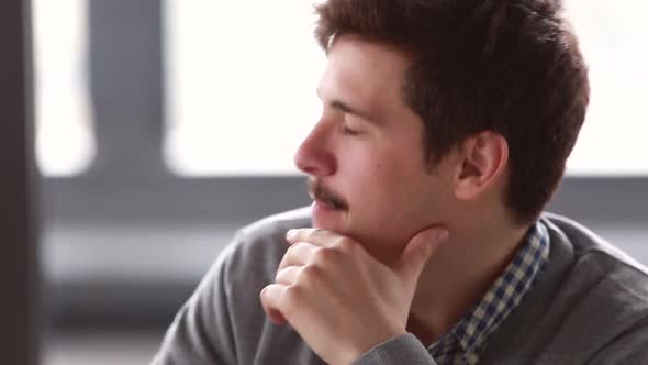Profile Of Young Businessman Talking In Meeting alt