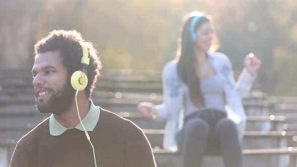 Man And Woman Listening To Music On Headphones And Dancing To The Rhythm alt