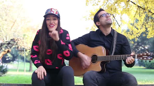 Beautiful Woman Singing While Handsome Man Playing Guitar 9 alt