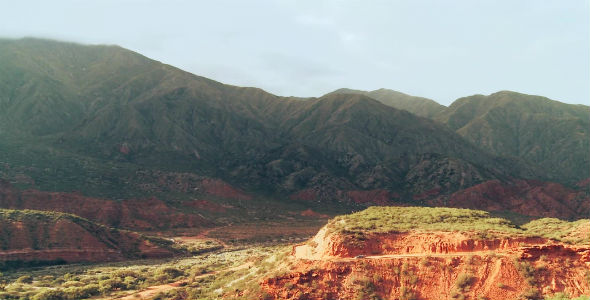 Dirt Road Winding Through Dusty Hills in La Rioja, Argentina alt