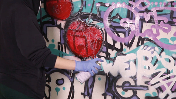 Young Girl Paints a Graffiti alt