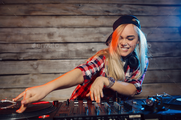 Cute dj woman having fun playing music at club party Stock Photo by arthurhidden
