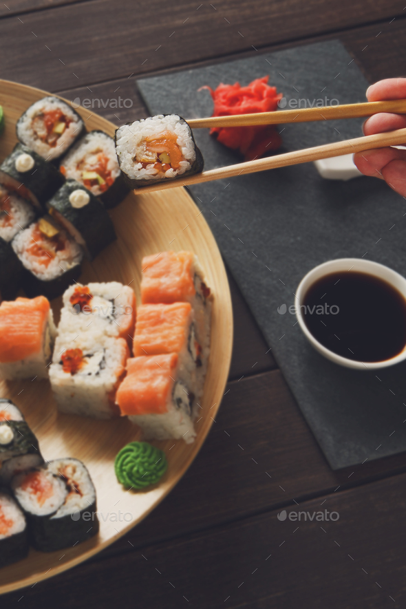Set of sushi maki and rolls at black rustic wood. - Stock Photo - Images