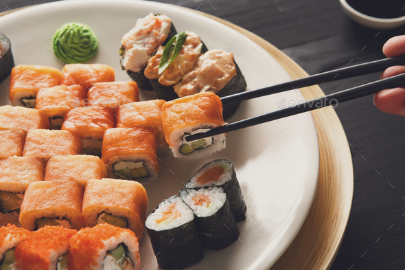 Eating sushi rolls at japanese food restaurant - Stock Photo - Images