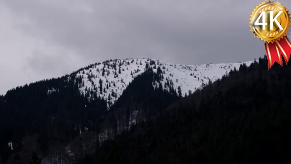 Snow Clouds Moving Across a Snowy Mountain