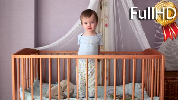Baby Boy Unhappy Standing in His Crib