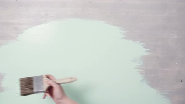 Home improvement project. Painting wood with turquoise color paint. alt