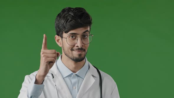 Arabic Doctor Man Smiling Hispanic Male Medical Worker Raises Index Finger Warns you to Be Attentive alt