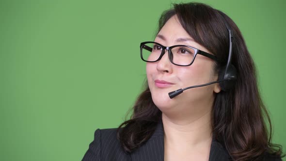 Mature Beautiful Asian Businesswoman Working As Call Center Representative alt