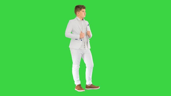 Teenager Boy in a White Suit Posing on a Green Screen Chroma Key alt