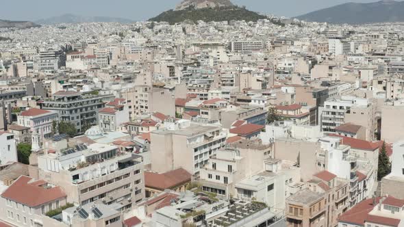 Slow Establishing Dolly Aerial Towards Mount Lycabettus Panning Down Into Athens City, Greece alt