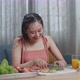 Smiling Asian Woman Slicing Cucumber While Preparing Healthy Food At Home - VideoHive Item for Sale