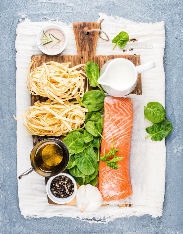 Ingredients for cooking pasta tagliatelle with salmon, spinach and cream - Stock Photo - Images