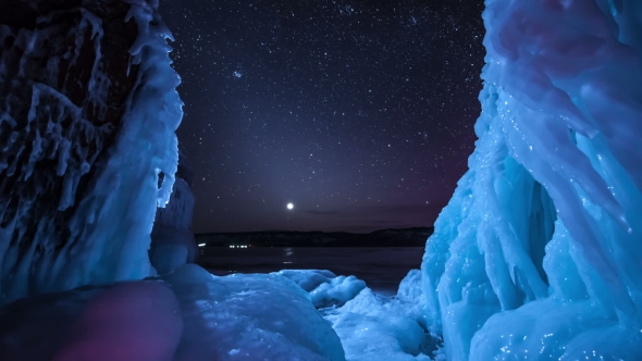 Rotating Stars And North Light Above Frozen Lake. 