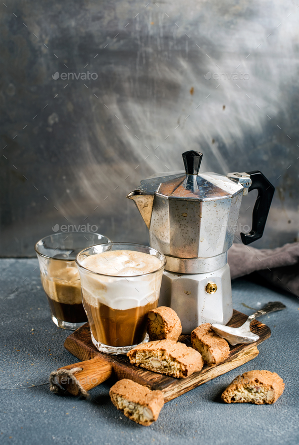 Glass espresso coffee on rustic wooden board, cantucci biscuits and steel  Italian Moka pot Stock Photo by sonyakamoz