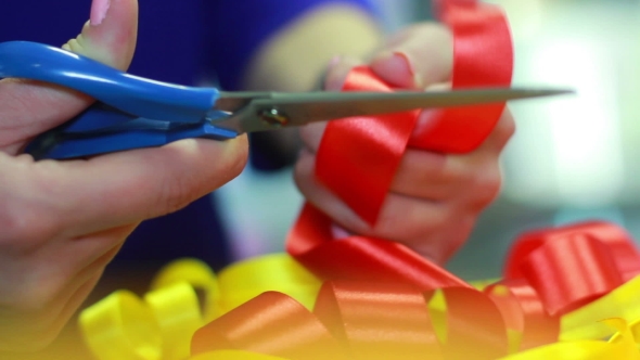 Red Ribbon Cutting With Scissors. Ribbons Decoration. Holiday Decoration alt