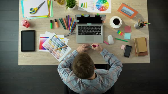 Inspired Male Creator Writing Down All His Ideas on Piece of Paper to Remember alt