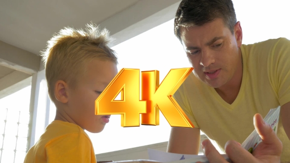 Father And Child Spending Leisure With Book alt