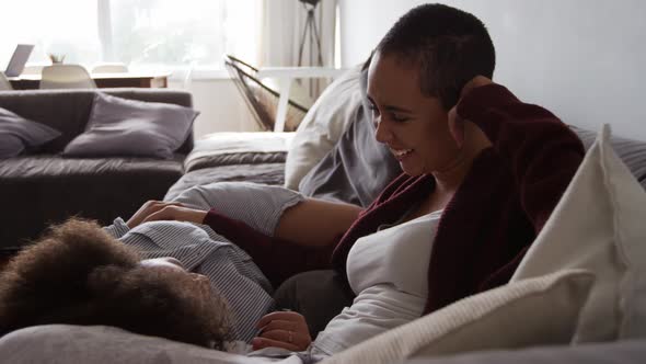 Lesbian couple romancing in living room alt