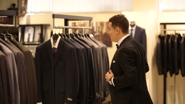 Man Tries On The Suit In The Store