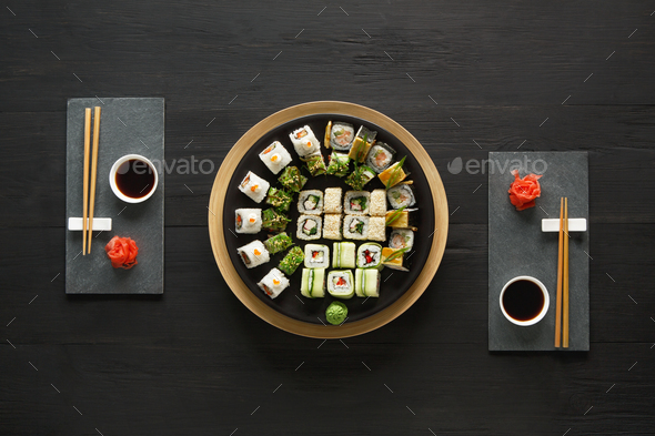 Set of sushi maki and rolls at black rustic wood. - Stock Photo - Images