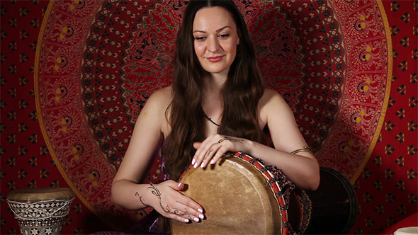 Woman Playing The Drum