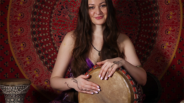 Young Caucasian Woman Playing The Drum