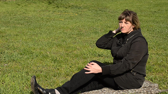 Woman Sitting on Green Grass