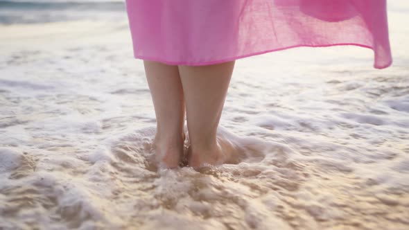 Slim Female Legs and Feet Close Up Woman Standing in Sea Waves on Sandy Beach alt