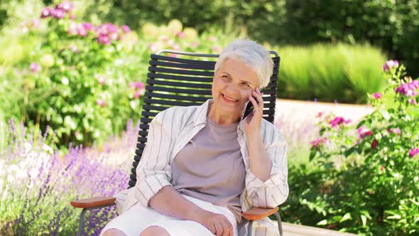 Happy Senior Woman Calling on Phone at Garden alt