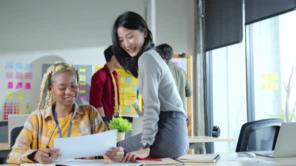 Couple of young female ux ui designers working at modern office