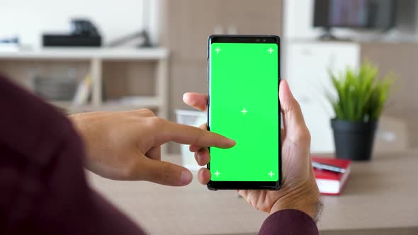 Man Hand Scrolling Down on a Smartphone with Green Screen Chroma Mock Up alt