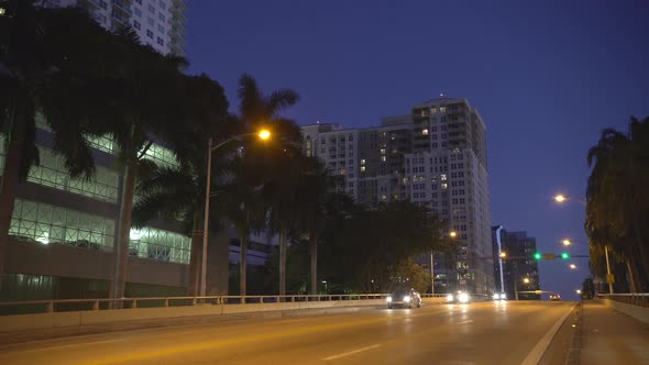 Driving in the city at dusk alt