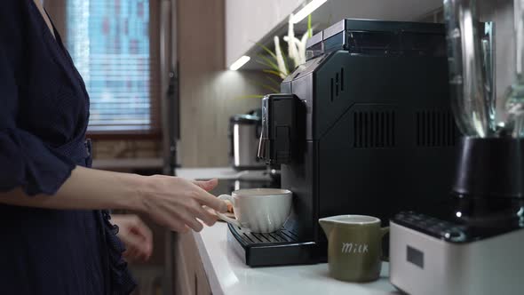Girl Prepares Morning Coffee in a Coffee Machine alt