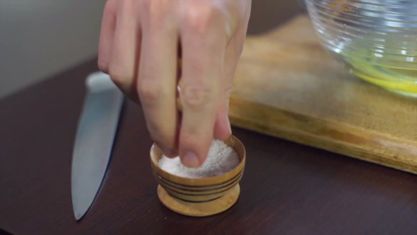 Cook Takes Salt To Salt Dish. Cooking Ingredient alt