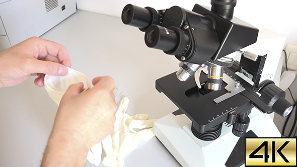 Scientist Using a Microscope In Laboratory 04