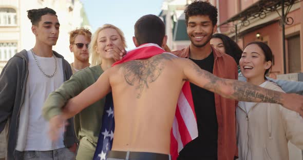 Young Protester with USA Flag Walks to Multiracial Activists and Hugging Them alt