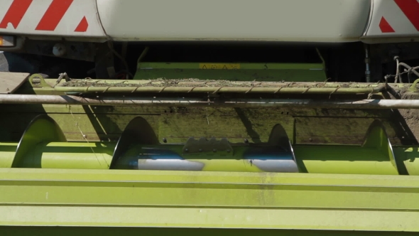 Farmer Combine Harvesting In Field alt