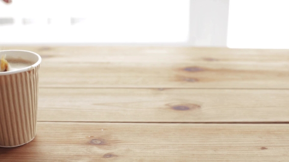 Hand Adding And Stirring Sugar In Cup Of Coffee 70 alt