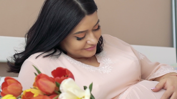 Happy Pregnant Girl Lying On The Bed alt