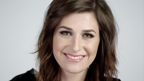 View of pretty girl on white screen smiling alt