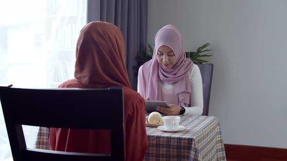Young muslim woman use smart watch contactless payment in coffee shop
