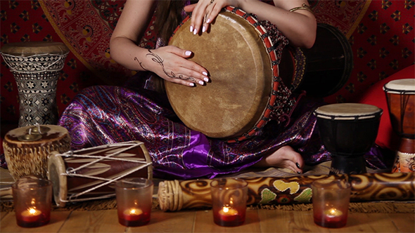 Caucasian Woman Playing Drum Indoors
