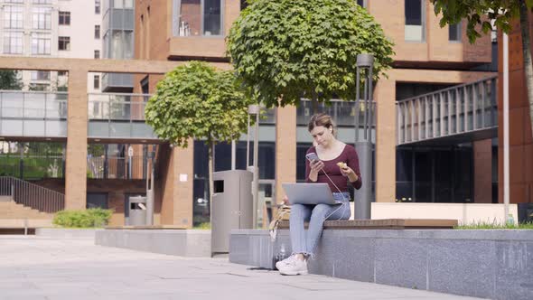 Young Businesswoman Working Remotely in City Park
