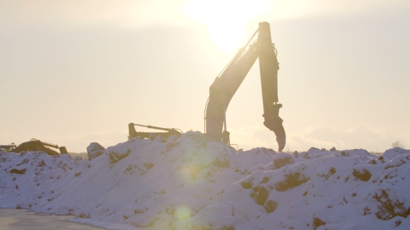 Excavators Digging The Ground In Winter Sunset alt