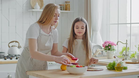 Mother Teaches Teenage Daughter Cook Mom with Little Girl Child Add Red Pepper Ingredients alt