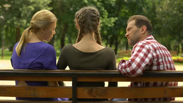 Teenage Daughter Quarreling With Parents in Park and Walking Away, Conflict alt
