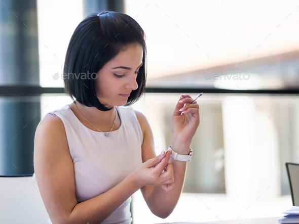 Woman adjusting at her watch