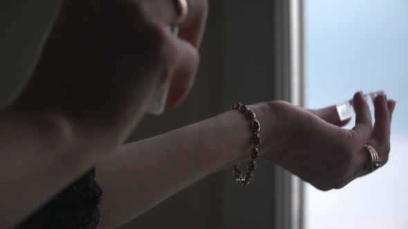 Spraying Perfume On Hand alt