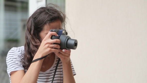 Girl Makes The Photo On The Old-school Camera And Smiling